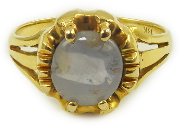 A modern 18k gold and single stone cabochon star sapphire set ring